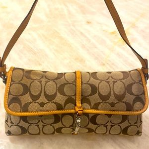 EUC Coach signature canvas tan small bag with leather details.